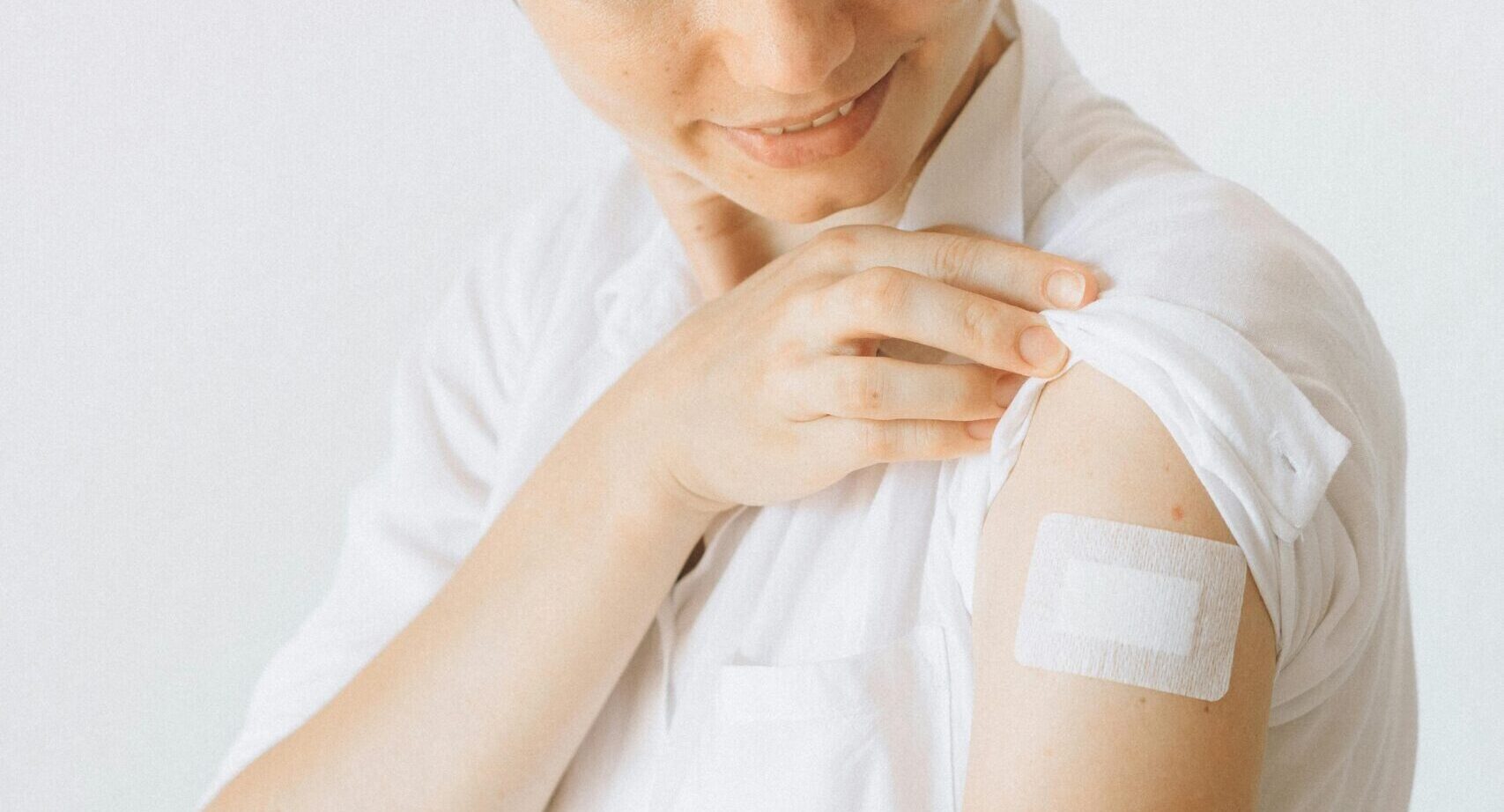 woman with band-aid on arm after a flu shot